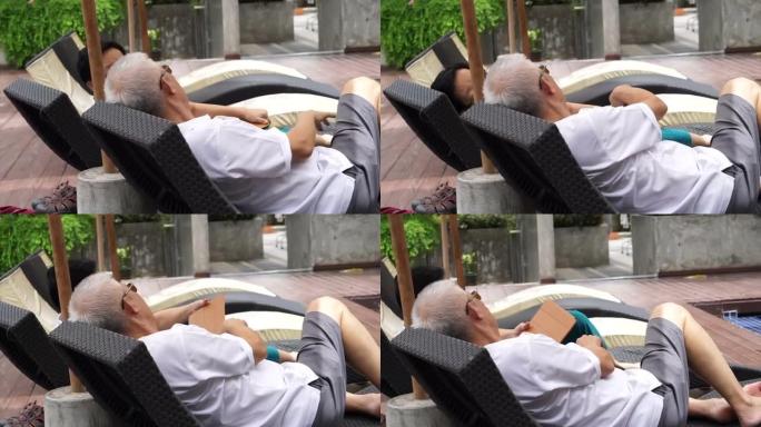 亚洲退休老年夫妇在假日娱乐旅行中在泳池边使用垫子
