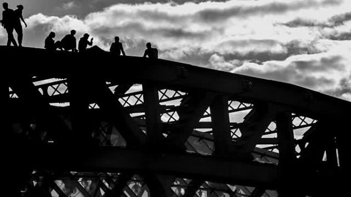 年轻人在不稳定的情况下漫步并互相拍照的剪影在桥顶上，时间流逝