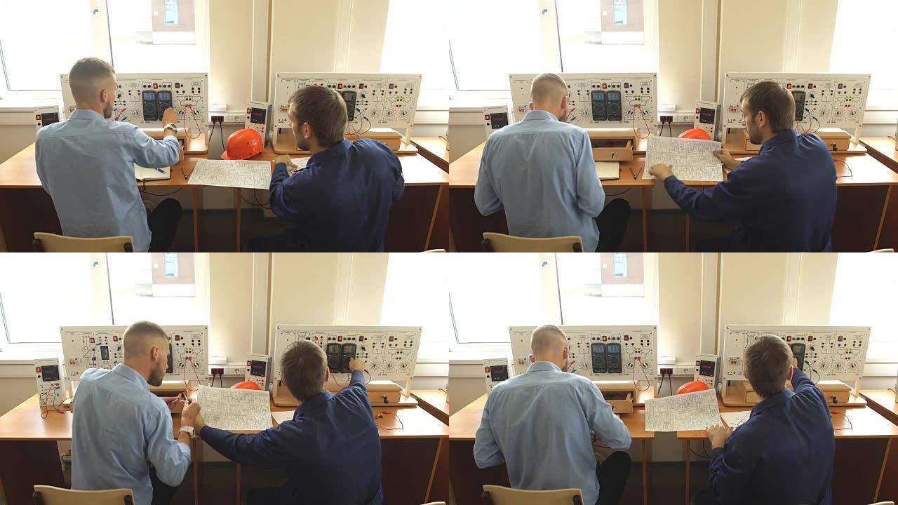 控制室工人的后视图，看着电脑显示器