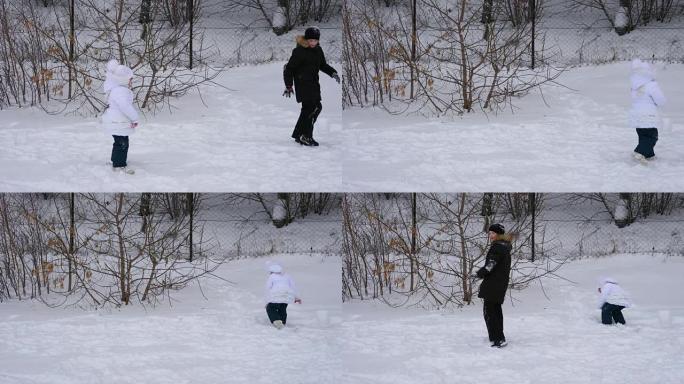 女童和青少年男孩玩雪球。冬季公园的孩子们。