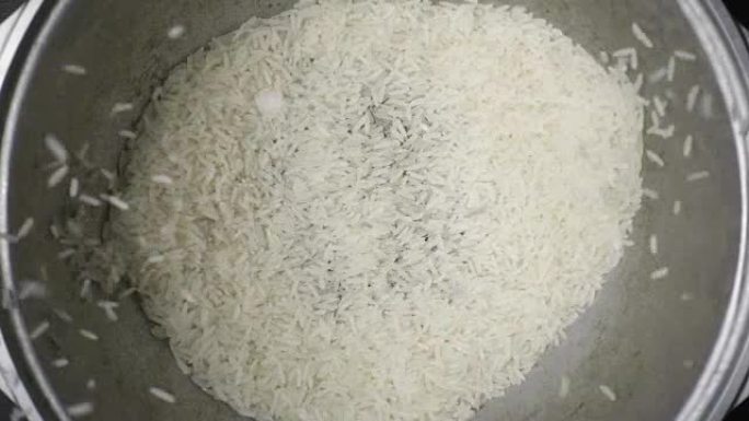 慢吞吞的莫龙粒米在锅里落下