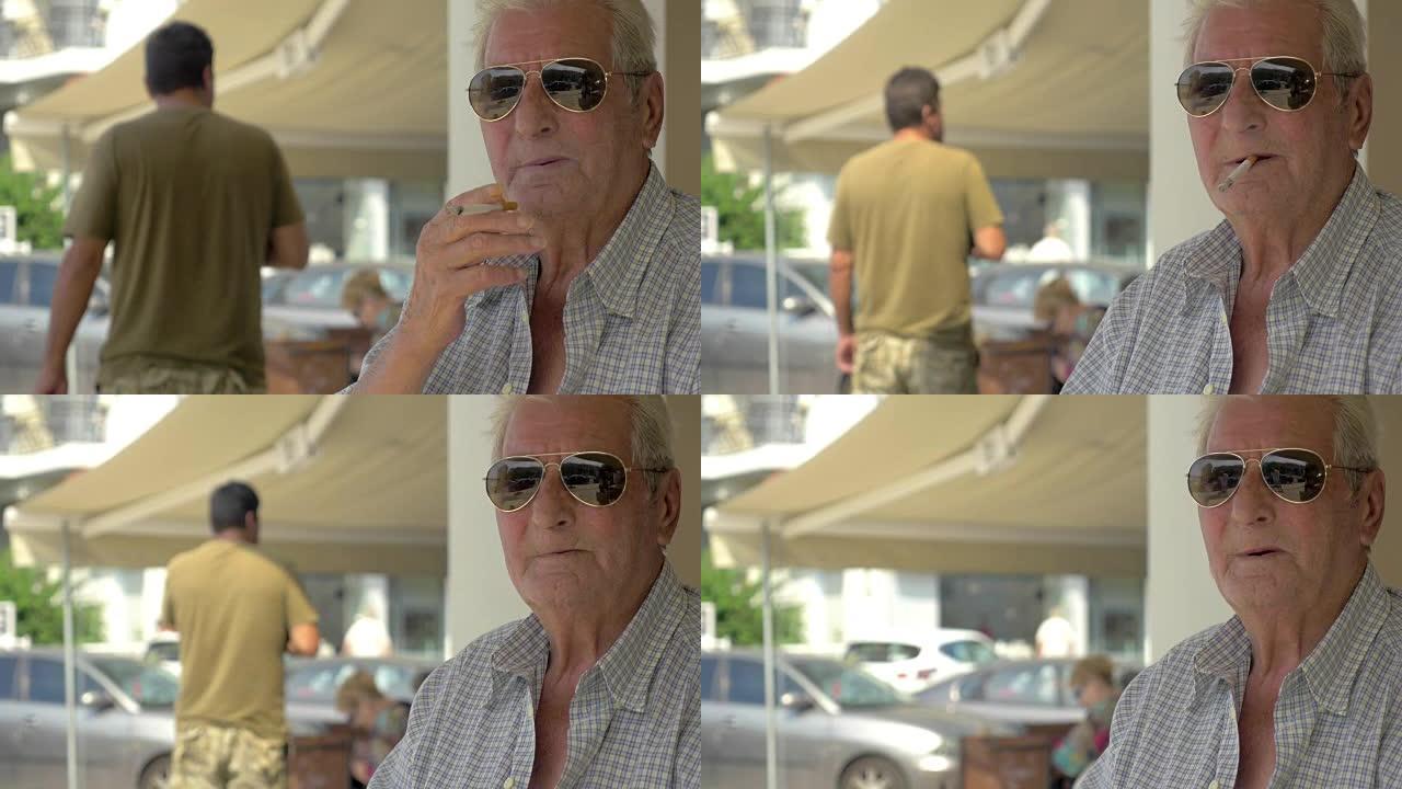 戴墨镜的老人在街上抽烟