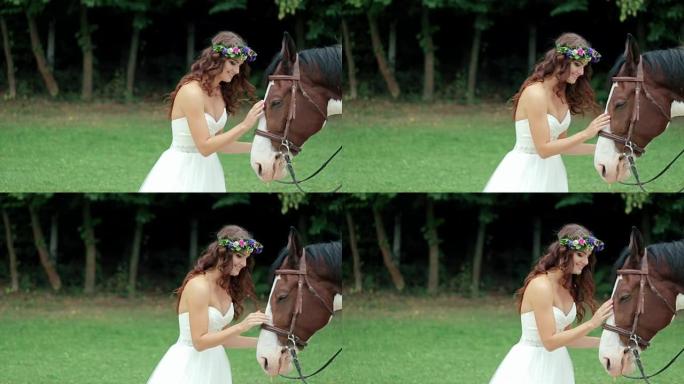 美丽的新娘和她的马在草地上