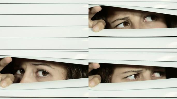 棕色眼睛的女孩打开白色的百叶窗，从一侧到另一侧，表情不赞成，可疑。