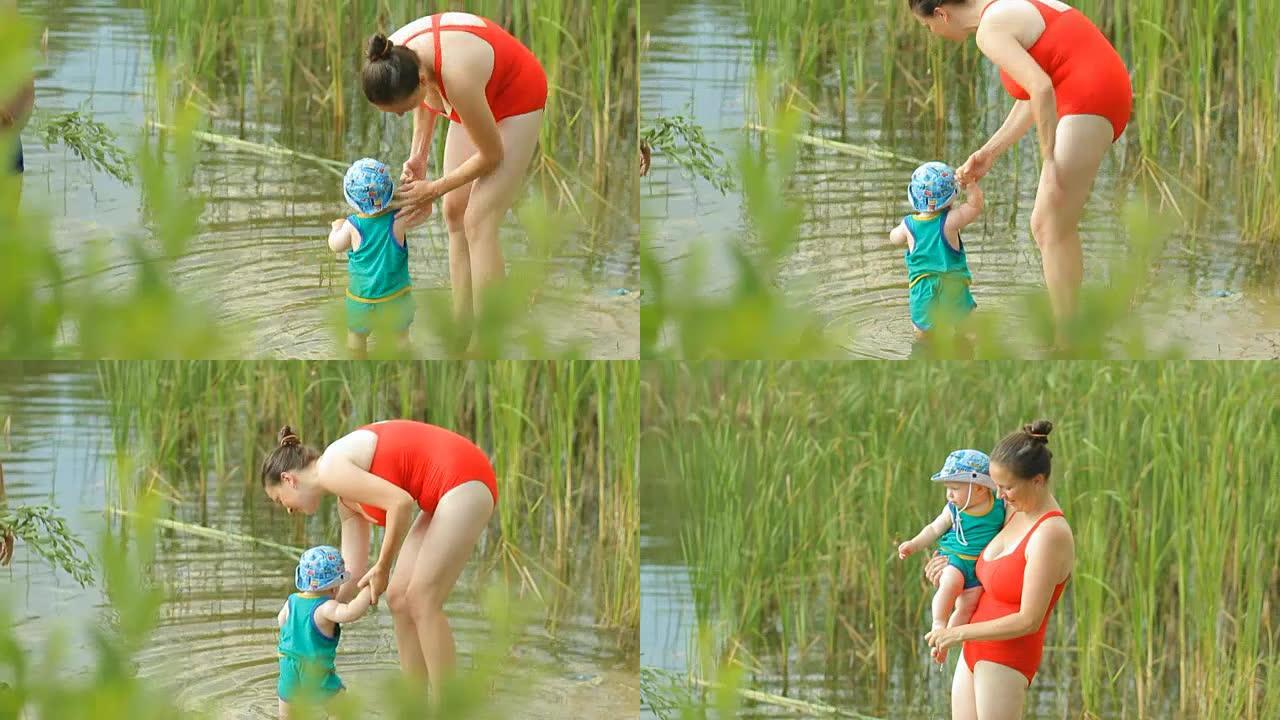 母亲和祖父在湖里和男婴玩耍。漂亮的孩子在水上行走