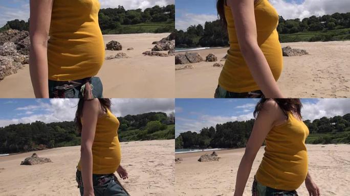 黄肚怀孕在海滩散步