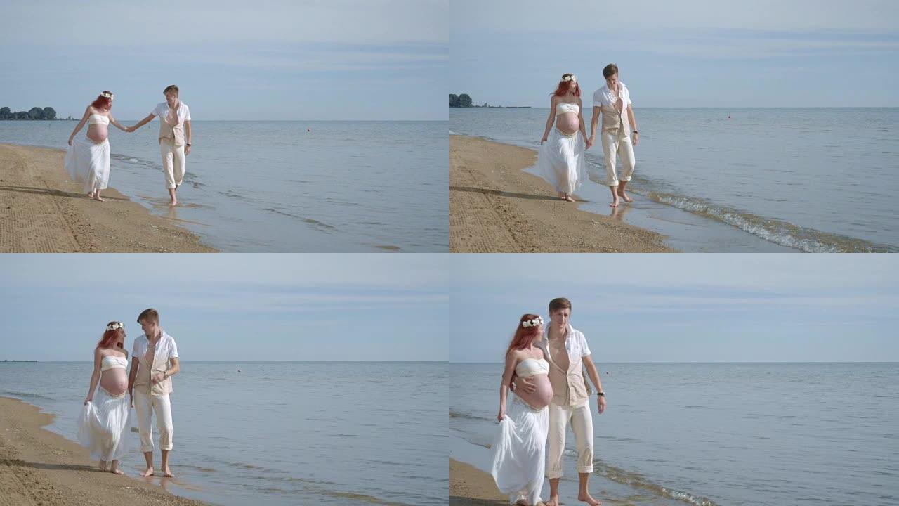 夫妇步行海滩。海边的怀孕夫妇。海滩上的孕妇