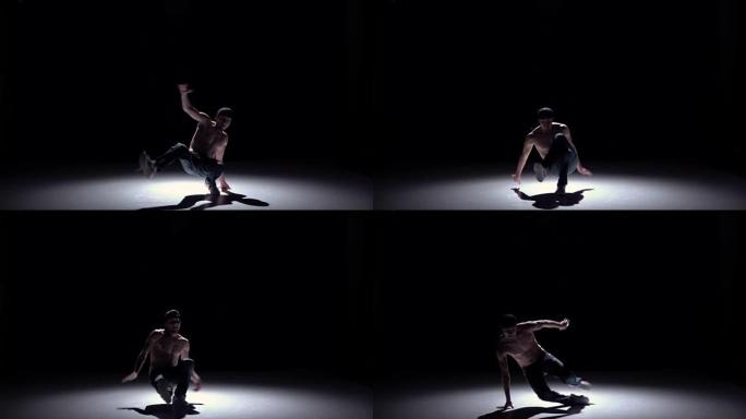 霹雳舞男子从坐着的姿势跳舞黑色，阴影，慢动作