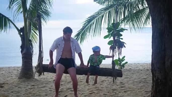 一个男人和一个孩子在沙滩上的绳子秋千上摇摆
