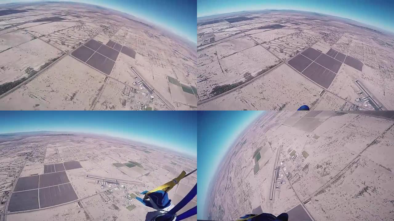专业跳伞运动员在空中打开降落伞，飞越亚利桑那州。晴天
