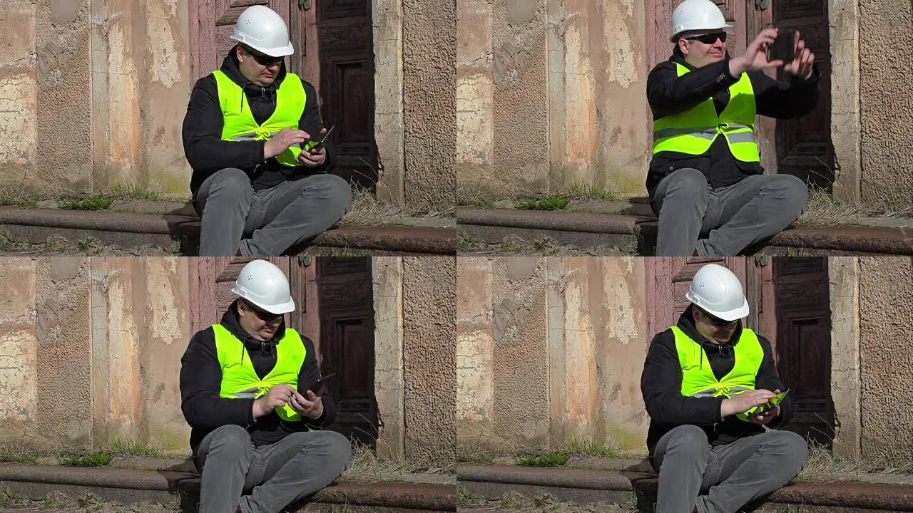 建筑检查员坐在智能手机上拍照