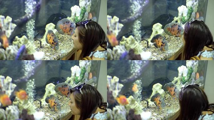 女人考虑水族馆装饰和鱼