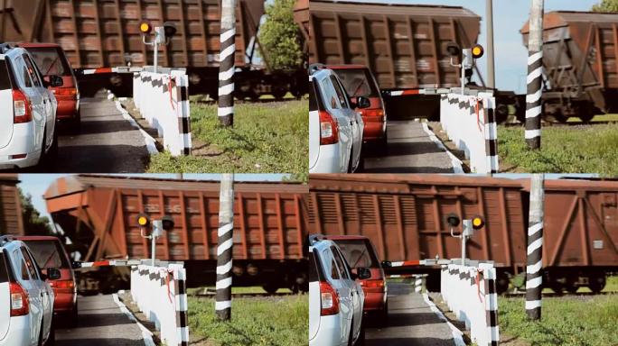 铁路运输。火车正在经过。机器正在等待障碍的打开。