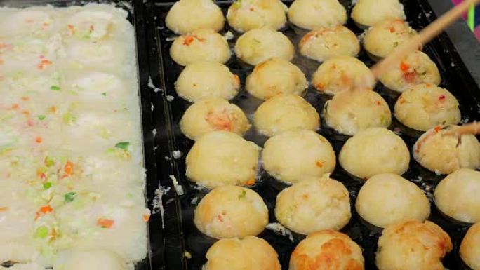 烹饪 “takoyaki” 球形饺子油炸小吃。日本街头美食