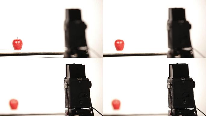 相机在拍摄过程中从苹果重新聚焦到老式相机