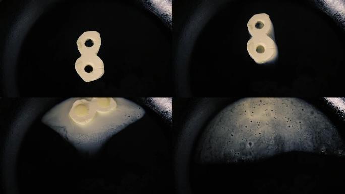 八号黄油在热锅上融化-特写顶视图