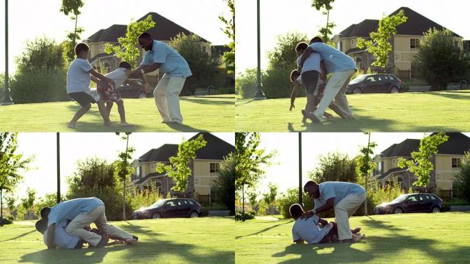 一位非洲父亲在公园的夏日与他的儿子玩耍。