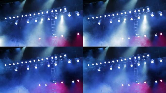 舞台上的照明设备。烟雾和蓝色和红色聚光灯。音乐表演，音乐会，表演
