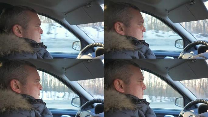 男人开车。特写简介。男人在他的车里，在冬天开车