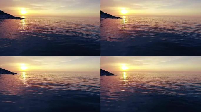 在海滩上拍摄美丽的夏日日落。海上日落无人机镜头