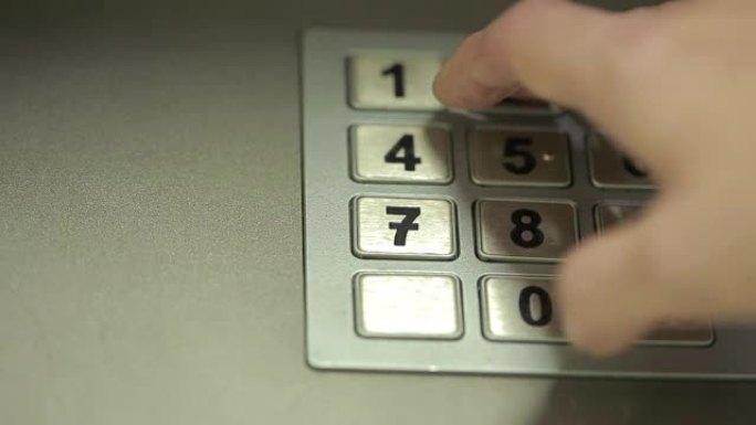 女人手触摸自动取款机。获取密码。