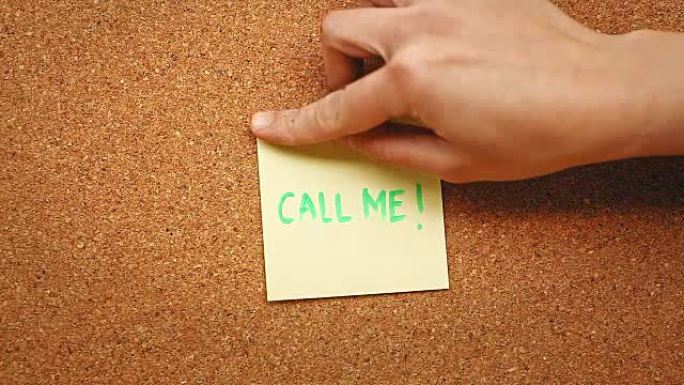 有人在软木板上贴上纸条，上面写着 “给我打电话”