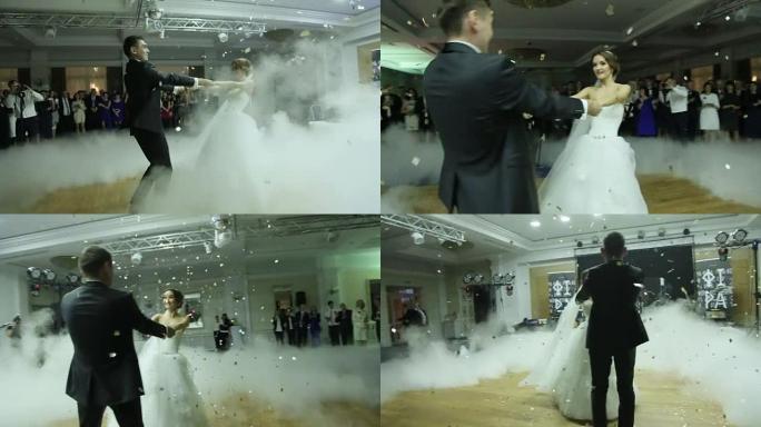 充满爱心的新婚夫妇在白烟笼罩的婚礼上跳舞第一支舞