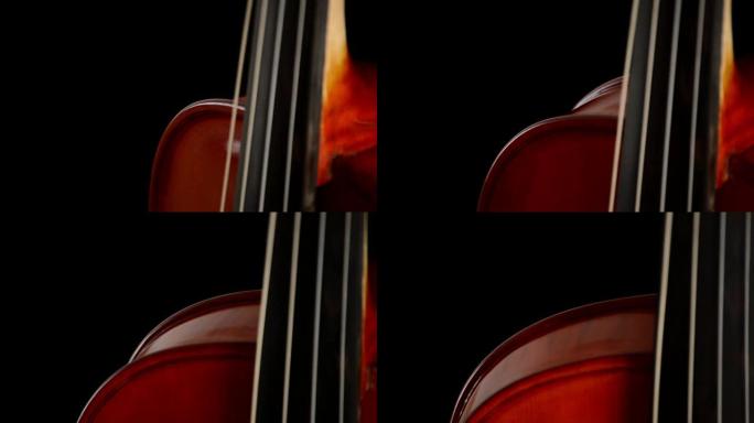 小提琴或中提琴乐器在黑色背景下转动的细节