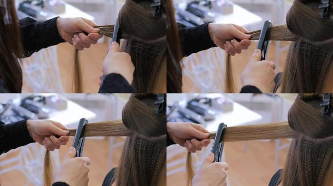 美发沙龙客户长发使用直发器的理发师