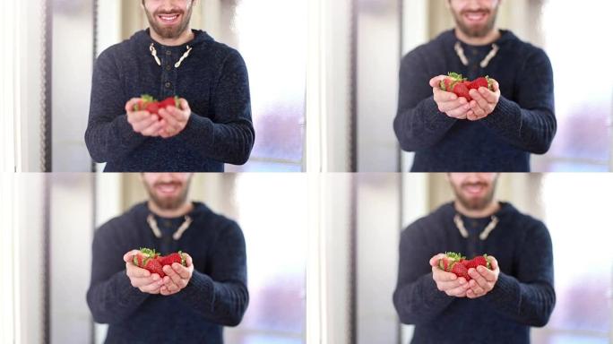 男人手里拿着新鲜草莓的观点