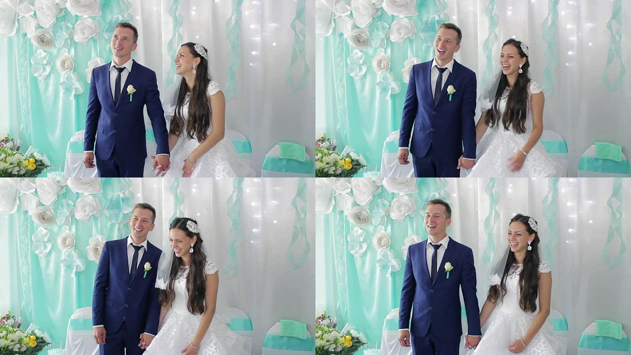 新娘和新郎在婚礼上鼓掌，大笑和亲吻