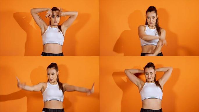 女rnb舞者。Vogue在工作室里对着橙色墙跳舞。