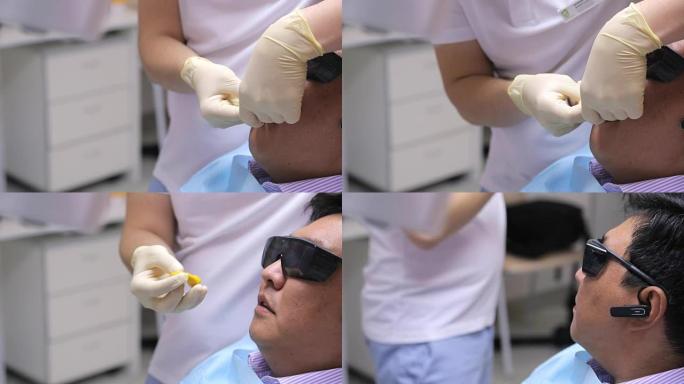 戴着白手套的牙医手将印模材料放在患者的口腔中，用于牙科石膏