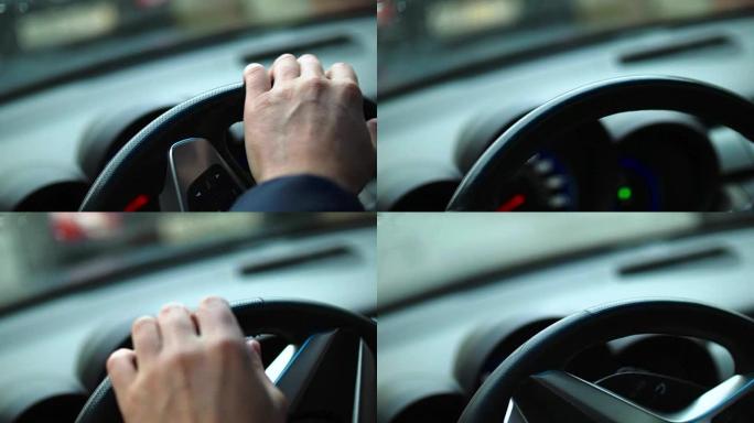 在交通拥堵中，男人的手紧张地打在汽车的方向盘上。特写