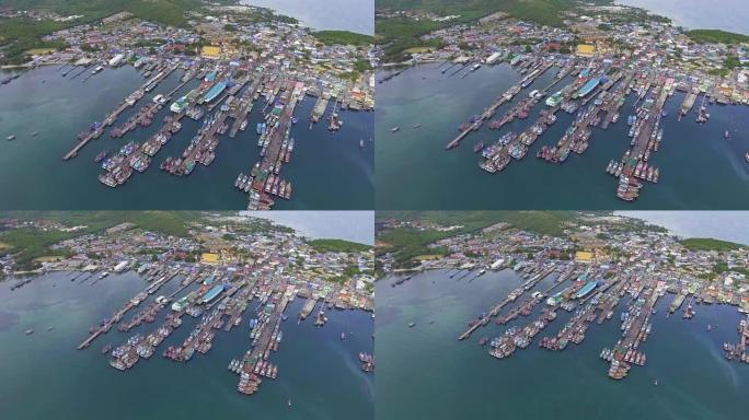 无人机在渔民村沿海岸紧张的港口鸟瞰图。飞走射击。