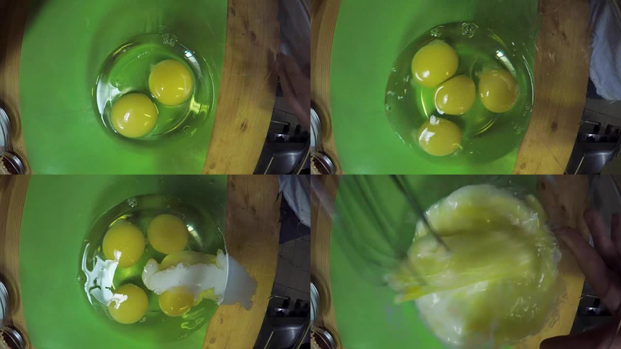 特写。男子在透明碗中砸碎鸡蛋并将其搅拌