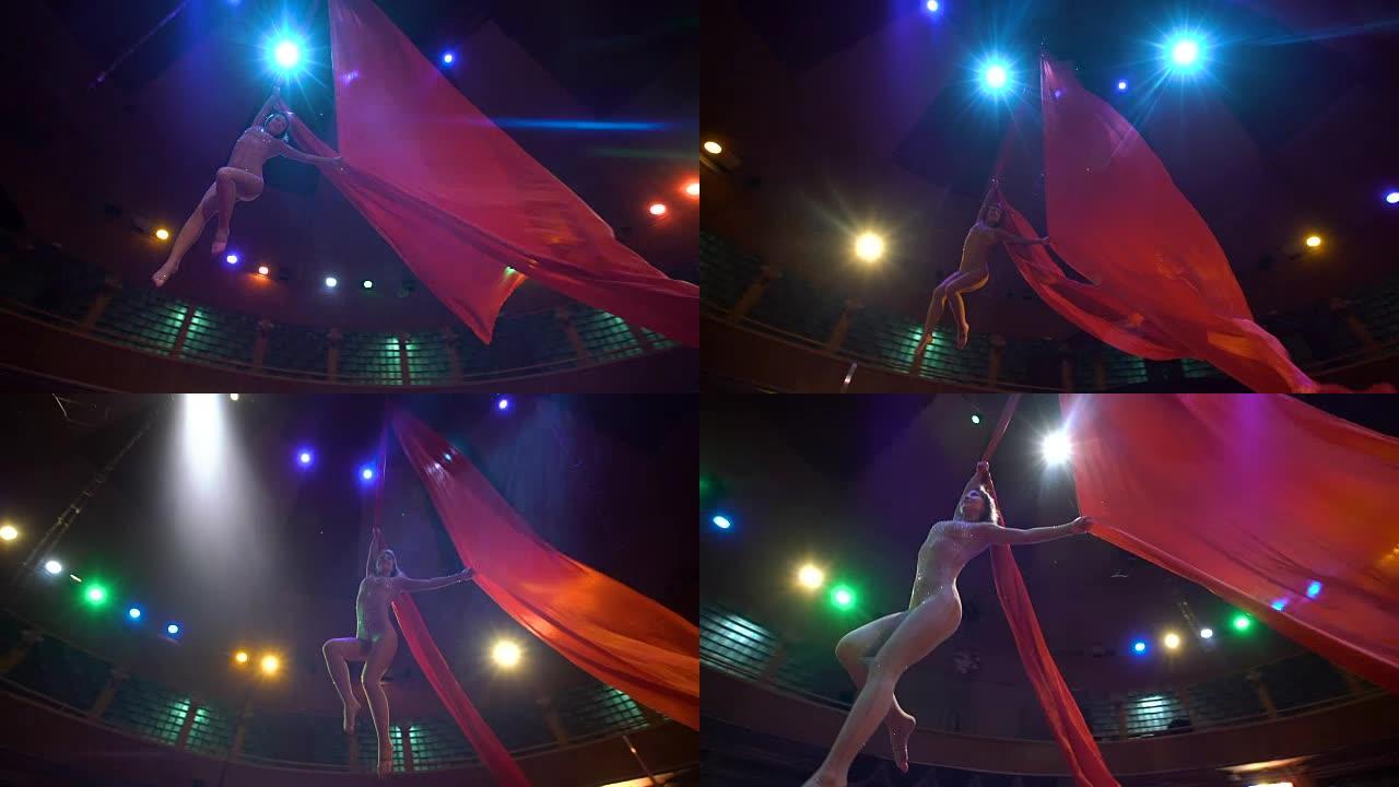 空中丝绸上的女舞者，空中扭曲，慢动作