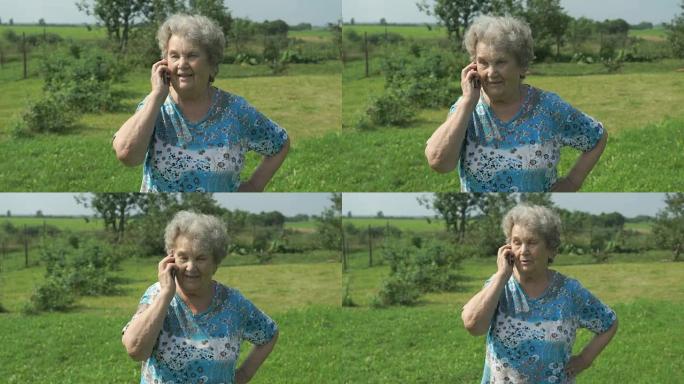 80年代的老妇人在户外智能手机上讲述