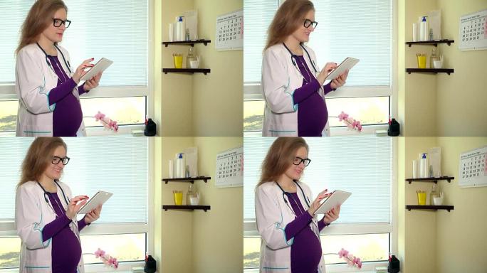 快乐的孕妇医生在工作中使用平板电脑和微笑