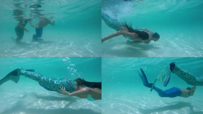 美人鱼夫妇从热带海滩在水下游泳