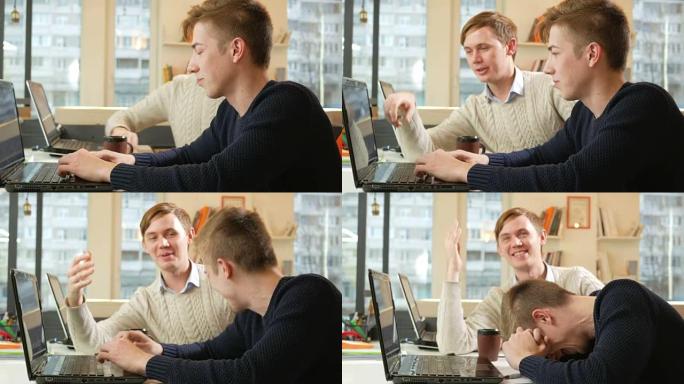 年轻人在笔记本电脑的办公室里工作，因为乏力而开始大笑