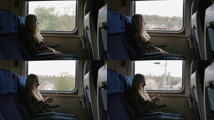 年轻的白人妇女乘火车旅行时透过窗户看