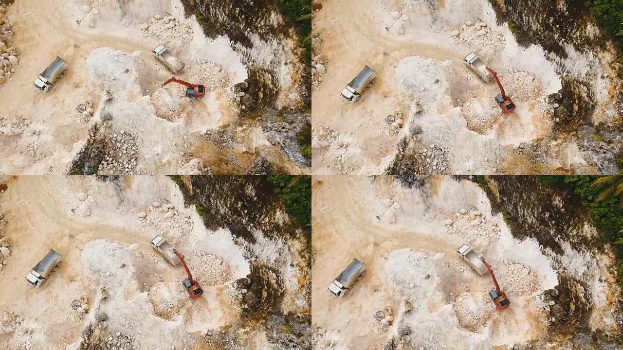 挖掘机在采石场装载卡车。菲律宾，锡亚高