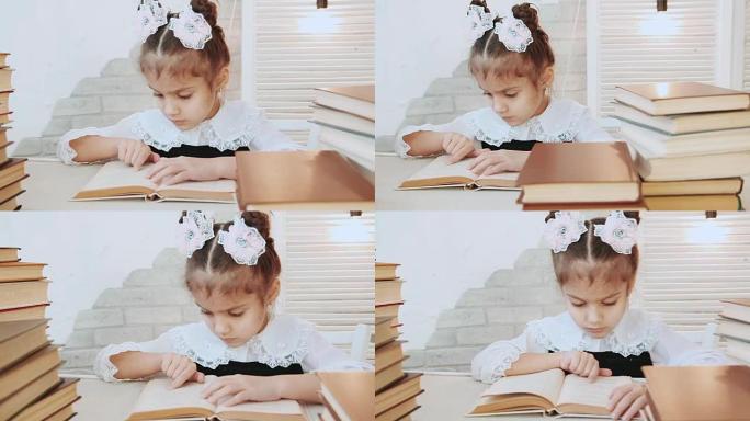 坐在桌子旁的一个孩子用手指穿过前景书堆中的书页。