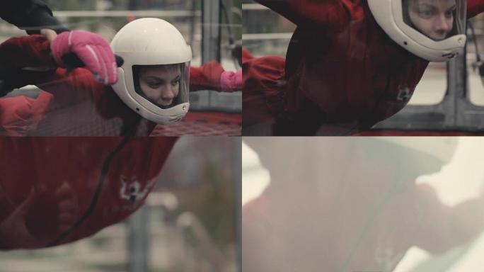 女子跳伞运动员在风洞中飞行。室内跳伞风洞