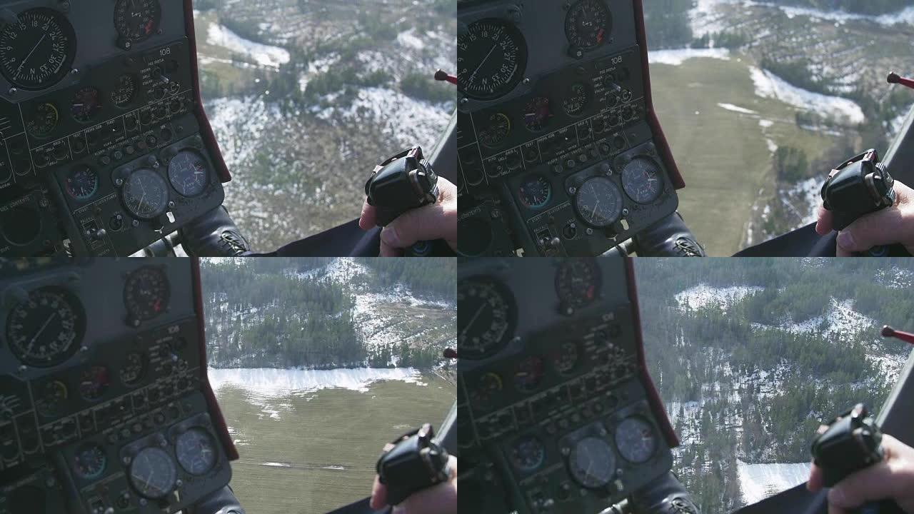 查看直升机的控制系统飞行员保持杆。驾驶舱的摄像头。森林之上。一些雪