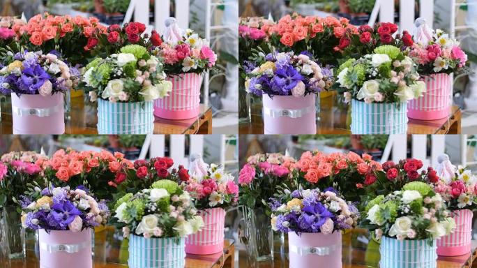 花店，在橱窗上，有很多由介子形玫瑰制成的花束，在五颜六色的盒子里有不同的花朵的花卉时尚组合