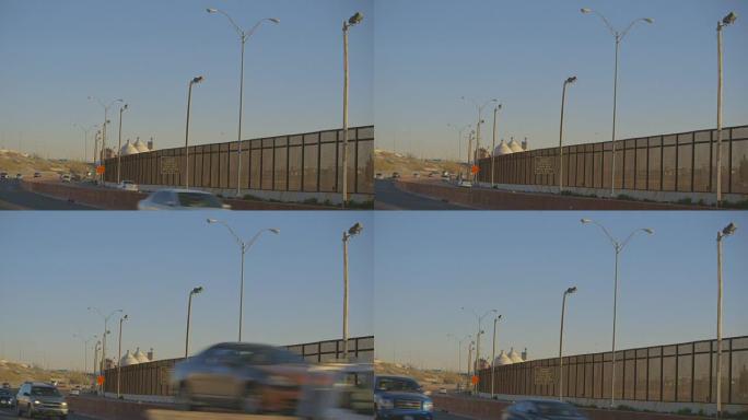 边境围栏旁高速公路上的车辆