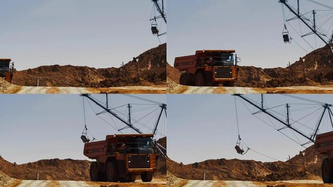 挖掘机将矿石装载到自卸车中。该地区已开采了布axite，铝和其他矿物。开放式。经营矿山。铝土矿采石场