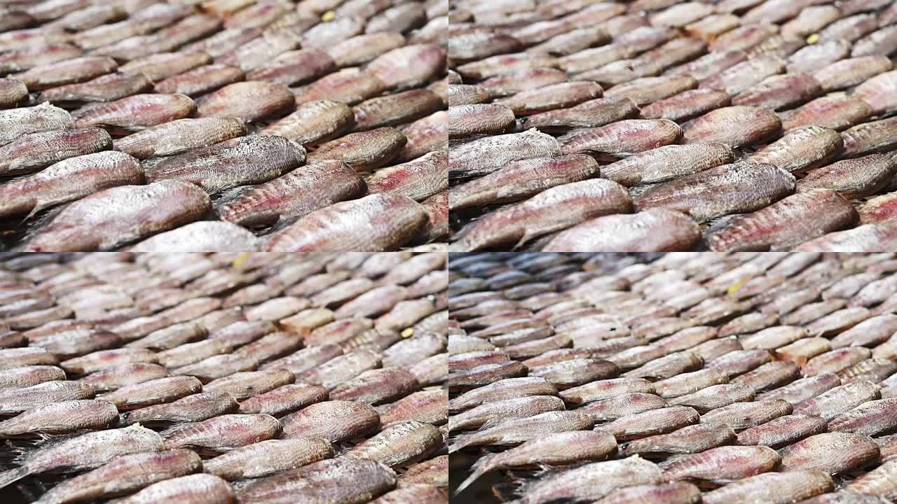 东南亚柳条桌上鱼片干燥的特写。腌渍海鲜